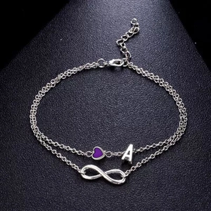 Detail of silver double-layer anklet with purple heart, letter A and infinity charm