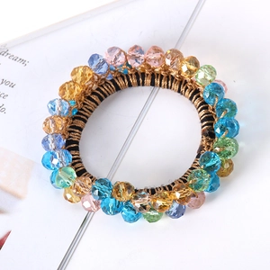 Detailed shot of elastic hair ring with colorful crystal beads and gold wire accents