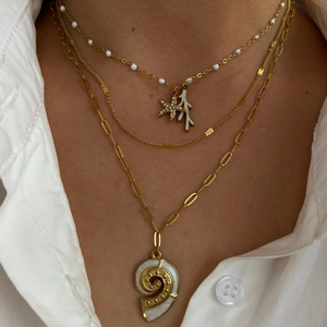 Layered 18K gold starfish and seashell pendant necklace with sparkling crystal accents