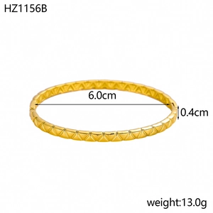 Macro detail of 18K gold-plated bangle with geometric patterns and size measurements