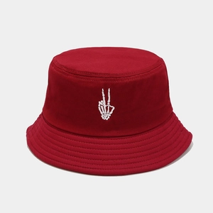 Detailed close-up of skull hand embroidery on a high-density burgundy cotton bucket hat