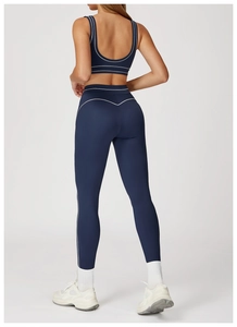 Detail of dark blue yoga set with white contrast stitching highlighting the body contours