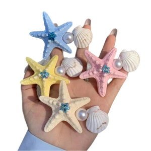 Starfish shell and pearl hair clips set with blue star rhinestones for beach vacation