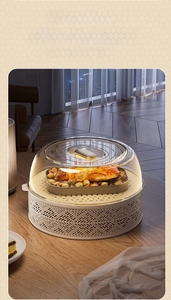 Detail of multi-layer food cover with transparent lid and woven base in warm home setting