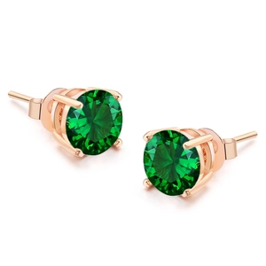 Detailed macro of green round-cut zircon earrings with rose gold four-prong setting