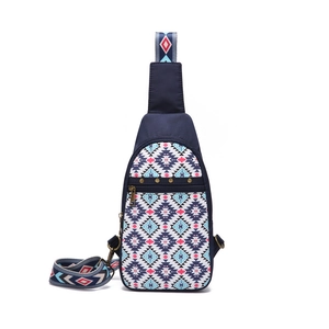 Macro detail of Aztec bohemian sling bag with tribal patterns and gold rivets