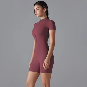 Close-up of flexible mauve sports bodysuit featuring a zipper stand collar and short sleeves