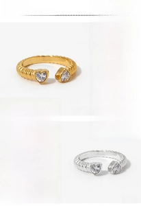 Macro shot of adjustable open heart zircon ring with gold and silver spiral textured bands