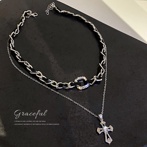 Double-layered leather and silver chain necklace with a sparkling diamond cross pendant