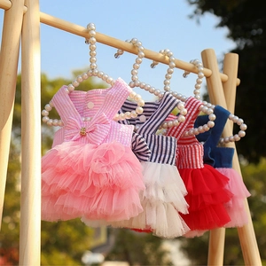 Detail of striped pet tutu dress with bow decoration and mesh skirt on pearl hanger