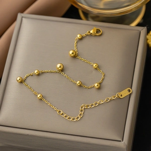Minimalist gold titanium steel bead bracelet with polished spheres and adjustable lobster clasp