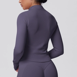 Detail view of ribbed knit texture and V-shape stitching on sports yoga wear jacket and pants