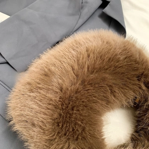 Close-up of premium fluffy brown faux fur fabric texture for elegant handbags