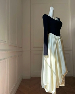 Detail of color-block knit dress with puff sleeves on mannequin in French studio