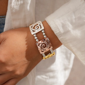 Detail of multi-strand beaded bracelet with rose gold 'follow your heart' engraved charm