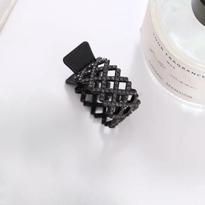Elegant black rhinestone claw clip with hollow grid design for a high ponytail hairstyle