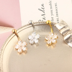 Three-piece set of floral belly rings in gold, silver, and rose gold with zircon stones