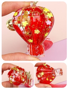 Macro view of red hot air balloon keychain with sparkling glitter and colorful sequins