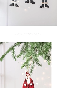 Handcrafted wooden Santa pendant with twine string hanging on a festive pine branch