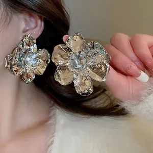 Dramatic large silver flower earrings with textured metal petals for high-fashion style