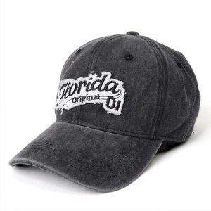Detail of vintage Florida embroidery patch on washed denim baseball cap with distressed edge