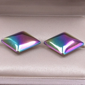 Macro detail of geometric square stud earrings with iridescent rainbow electroplated finish