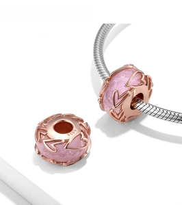 Detailed macro view of S925 sterling silver heart bead with faceted pink crystal