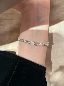 Detail of silver chain bracelet with micro-pave zircons and geometric toggle design