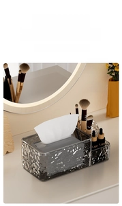 Close-up of a grey acrylic tissue box with glacier water ripples and storage sections
