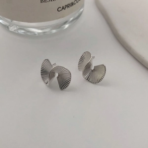 Close-up of matte S925 sterling silver fan-shaped stud earrings with pleated texture