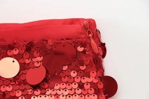Close-up of red sequin A-line skirt featuring a premium matching invisible zipper detail