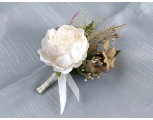 Detail of elegant white artificial peony boutonniere with vintage brown flowers and silk ribbon