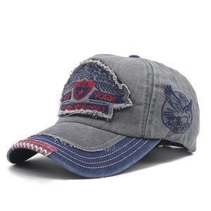 Detail of vintage baseball cap featuring New York 1985 embroidery and distressed edges