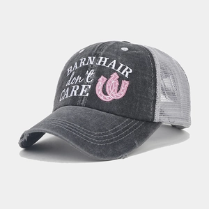 Close-up of distressed ponytail cap with Barn Hair Don't Care embroidery and mesh details