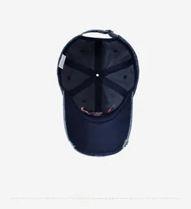 Internal detail of washed navy baseball cap showing stitching and metal buckle strap
