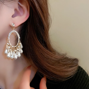 Elegant gold oval earrings with sparkling rhinestones and dangling imitation pearl tassels