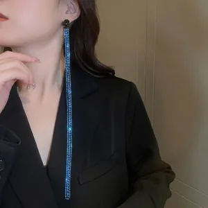 Sparkling long tassel snake-shaped earrings with navy blue rhinestones on model