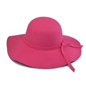 Detail of rose pink wide brim felt hat with elegant ribbon bow decoration