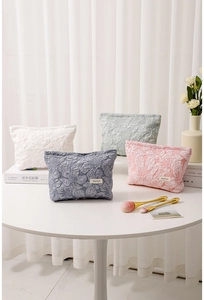 Detailed relief floral textures on large canvas makeup bags in four pastel colors