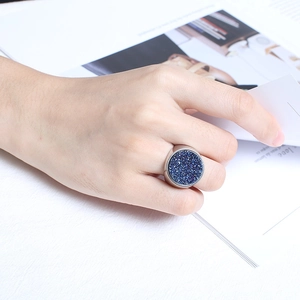 Women's silver stainless steel ring with a large round dark blue glitter inlay