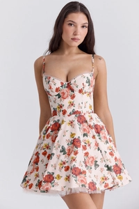 Detailed view of floral mini dress featuring tiered mesh hem and waist silhouette