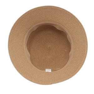Detail view of woven straw hat interior featuring the sweatband and material care label