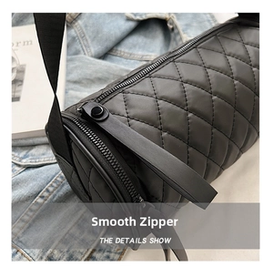 Close-up of quilted cylinder bag showing smooth zipper detail and nylon texture