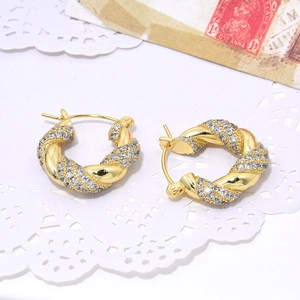 U-shaped golden twist hoop earrings with pavé cubic zirconia and lace decor