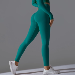 Detail view of teal high-waist seamless yoga pants with scrunch butt lifting design