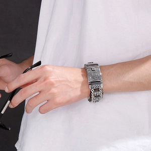 Close-up of vintage leather cord braided chain bracelet with intricate punk steel carving