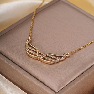 Elegant gold wing pendant necklace with cubic zirconia displayed on luxury gift box