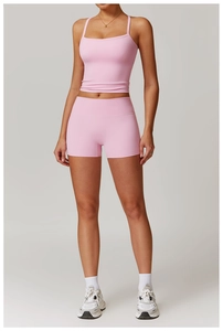 Detail of pink brushed racerback yoga tank top and high waist compression shorts set