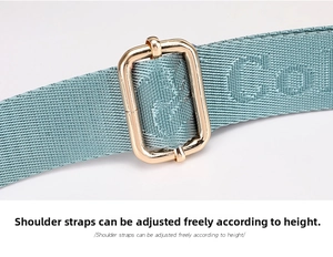 Detail of adjustable nylon strap with gold metal buckle and textured lettering