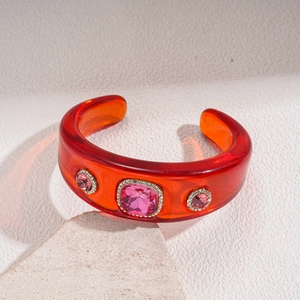 Detail of retro resin cuff bracelet featuring a large pink square gemstone with crystal pavé